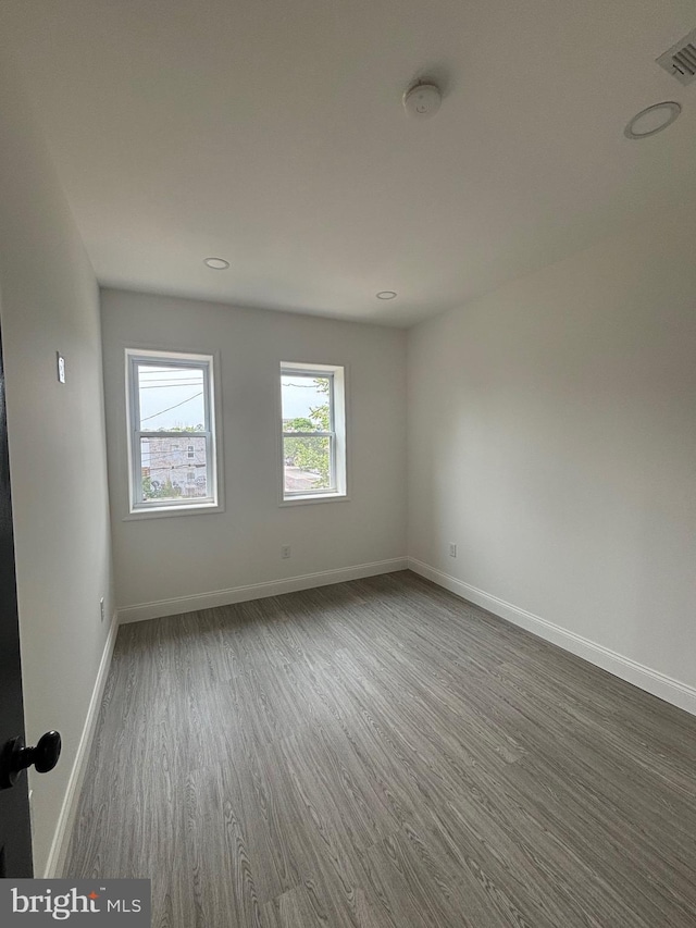 1748 N Chester St, Baltimore, MD 21213 - spare room featuring dark wood finished floors, baseboards, and recessed lighting