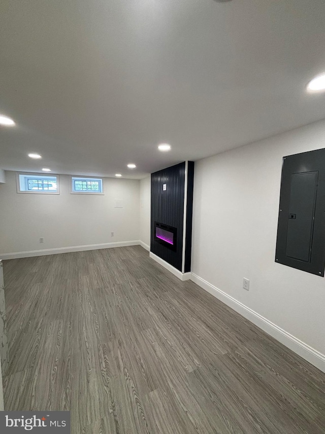 1748 N Chester St, Baltimore, MD 21213 - below grade area with electric panel, wood finished floors, recessed lighting, a large fireplace, and baseboards