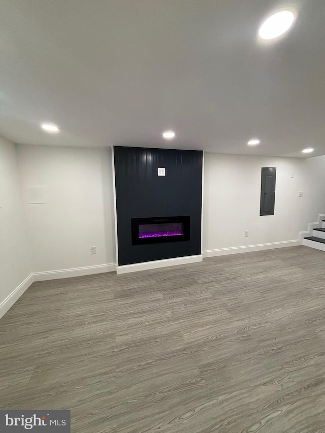 1748 N Chester St, Baltimore, MD 21213 - finished below grade area featuring electric panel, recessed lighting, stairs, a large fireplace, and baseboards