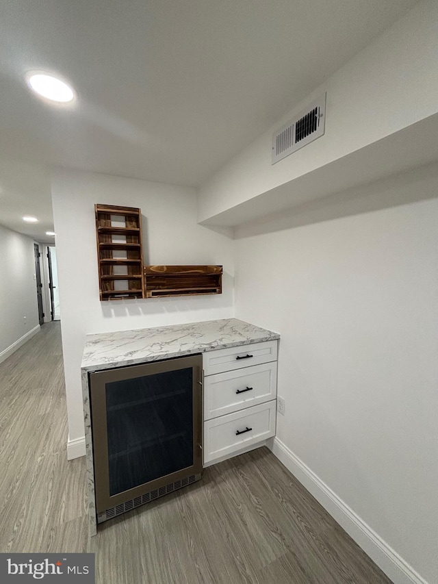 1748 N Chester St, Baltimore, MD 21213 - detailed view of beverage cooler, baseboards, wood finished floors, and recessed lighting