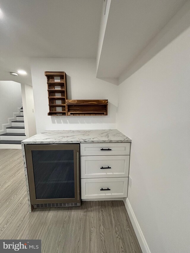 1748 N Chester St, Baltimore, MD 21213 - detailed view of wine cooler, wood finished floors, baseboards, and a dry bar