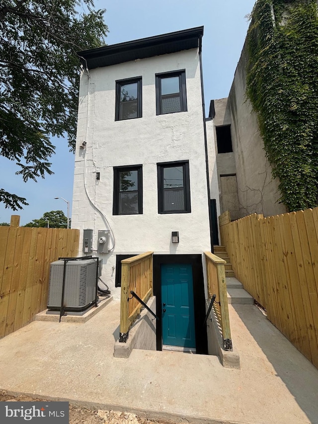 1748 N Chester St, Baltimore, MD 21213 - back of house with central air condition unit and stucco siding