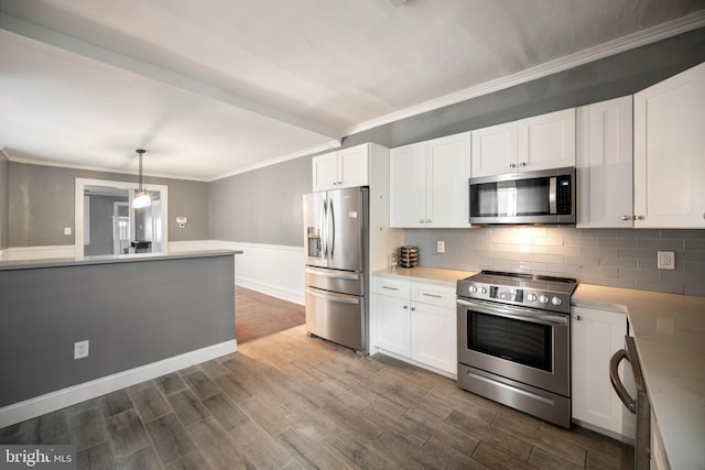 267 S 63rd St, Philadelphia, PA 19139 - kitchen featuring appliances with stainless steel finishes, crown molding, white cabinets, dark wood-style floors, and light countertops