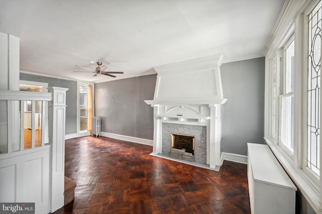 267 S 63rd St, Philadelphia, PA 19139 - unfurnished living room featuring radiator heating unit, a fireplace with flush hearth, a ceiling fan, crown molding, and baseboards