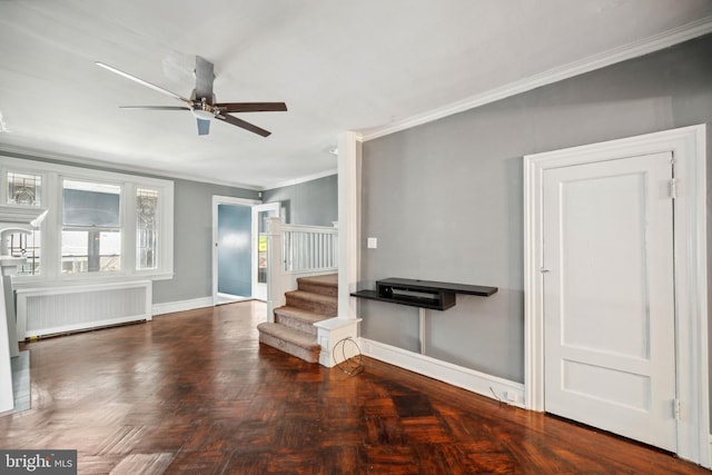 267 S 63rd St, Philadelphia, PA 19139 - unfurnished living room with radiator heating unit, ceiling fan, ornamental molding, baseboards, and stairway