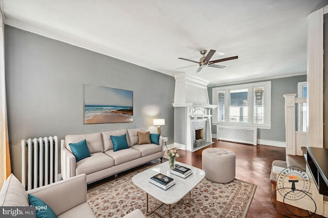 267 S 63rd St, Philadelphia, PA 19139 - living area with radiator, ornamental molding, a ceiling fan, baseboards, and a fireplace