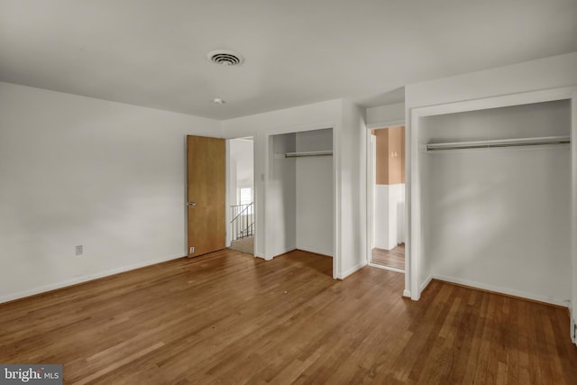 1401 Rockland St, Reading, PA 19604 - unfurnished bedroom featuring two closets, wood finished floors, and baseboards