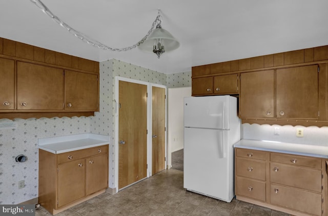 1401 Rockland St, Reading, PA 19604 - kitchen with freestanding refrigerator, wallpapered walls, light countertops, and brown cabinets
