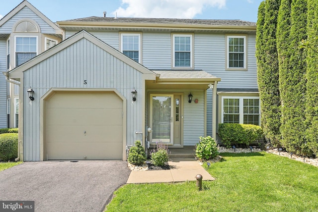 5 Locust Ln, Newtown, PA 18940 - view of front of property featuring asphalt driveway, a front lawn, an attached garage, and board and batten siding