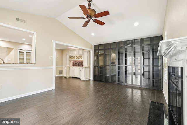 5 Locust Ln, Newtown, PA 18940 - unfurnished living room with dark wood finished floors, ceiling fan, vaulted ceiling, a glass covered fireplace, and baseboards