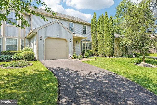5 Locust Ln, Newtown, PA 18940 - traditional-style home featuring driveway, a garage, a front yard, and board and batten siding