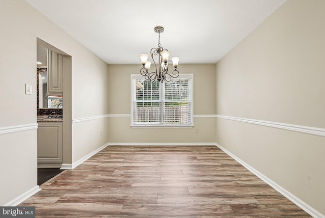 5 Locust Ln, Newtown, PA 18940 - unfurnished dining area featuring a chandelier, wood finished floors, and baseboards