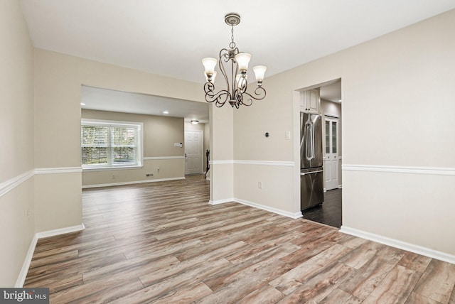 5 Locust Ln, Newtown, PA 18940 - spare room with wood finished floors, a chandelier, and baseboards