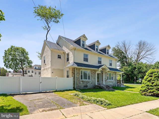 285 N Lansdowne Ave, Lansdowne, PA 19050 - view of front facade with stone siding, a gate, stucco siding, and roof with shingles