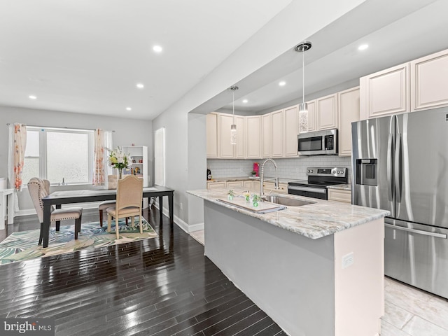 285 N Lansdowne Ave, Lansdowne, PA 19050 - kitchen with stainless steel appliances, a sink, light stone counters, tasteful backsplash, and recessed lighting