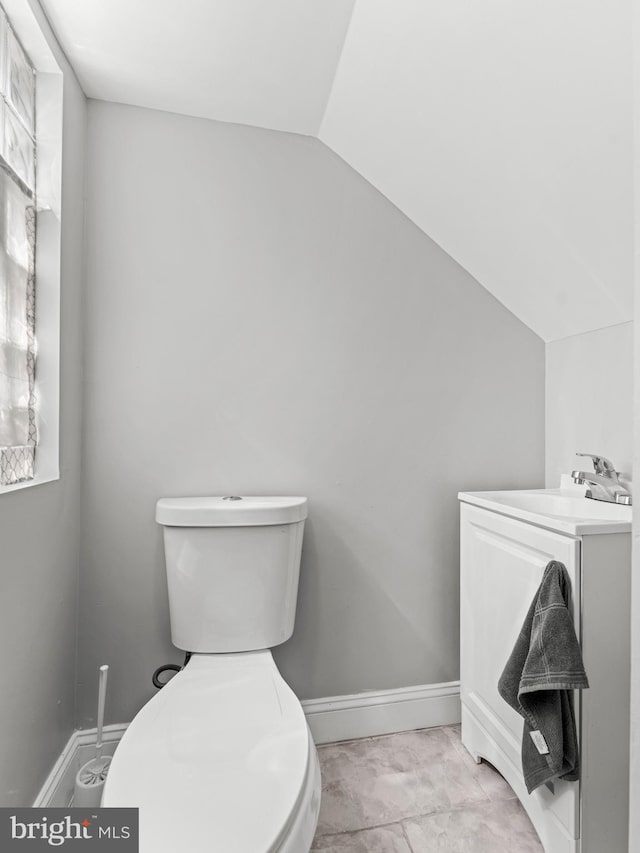 285 N Lansdowne Ave, Lansdowne, PA 19050 - bathroom featuring vaulted ceiling, toilet, vanity, and baseboards