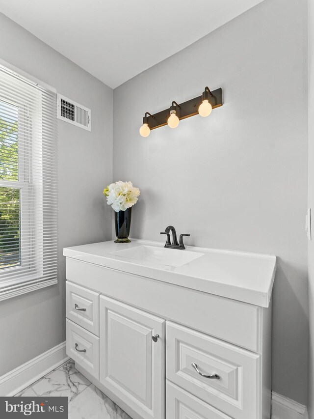 285 N Lansdowne Ave, Lansdowne, PA 19050 - bathroom featuring baseboards, marble finish flooring, and vanity