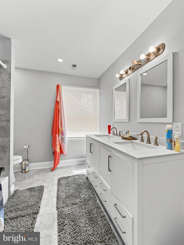 285 N Lansdowne Ave, Lansdowne, PA 19050 - bathroom featuring marble look tiles, double vanity, a tub to relax in, toilet, and a shower