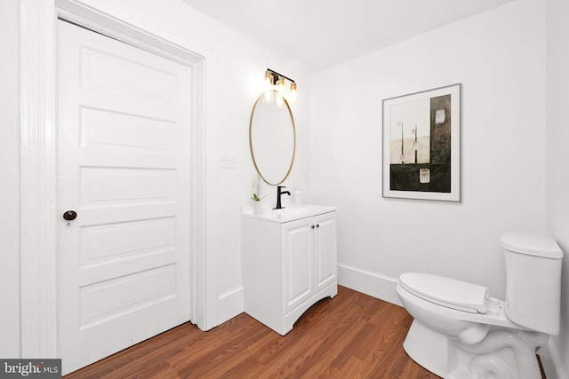 12 Layton Ave S, Camden Wyoming, DE 19934 - half bathroom with vanity, wood finished floors, toilet, and baseboards