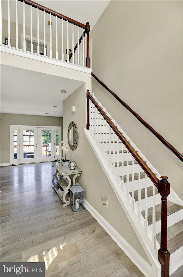 35 Krall Rd, Myerstown, PA 17067 - staircase featuring french doors, baseboards, wood finished floors, and a high ceiling