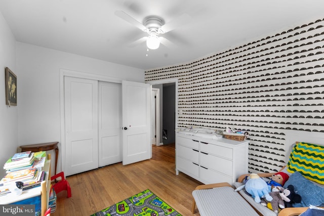 6807 Radcliffe Dr, Alexandria, VA 22307 - recreation room with wallpapered walls, a ceiling fan, and light wood-style flooring