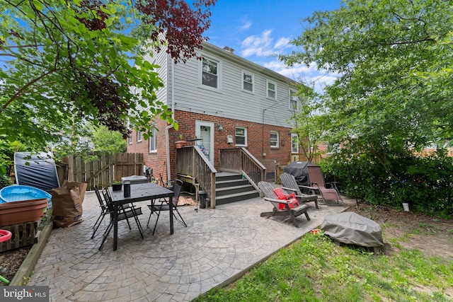 6807 Radcliffe Dr, Alexandria, VA 22307 - rear view of property featuring a patio area, brick siding, and outdoor dining space