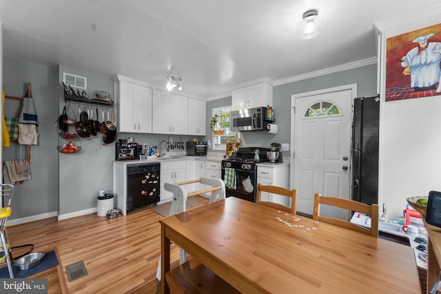 6807 Radcliffe Dr, Alexandria, VA 22307 - dining space featuring light wood-type flooring, baseboards, and crown molding