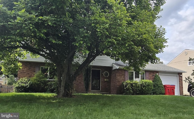 112 Gibson Ave, Warminster, PA 18974 - view of front of home featuring an attached garage, brick siding, and a front lawn