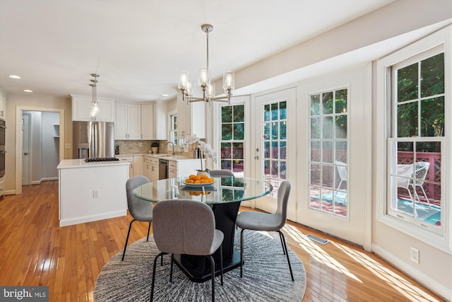 19802 Shady Brook Way, Gaithersburg, MD 20879 - dining room with healthy amount of natural light, a chandelier, light wood-type flooring, and recessed lighting