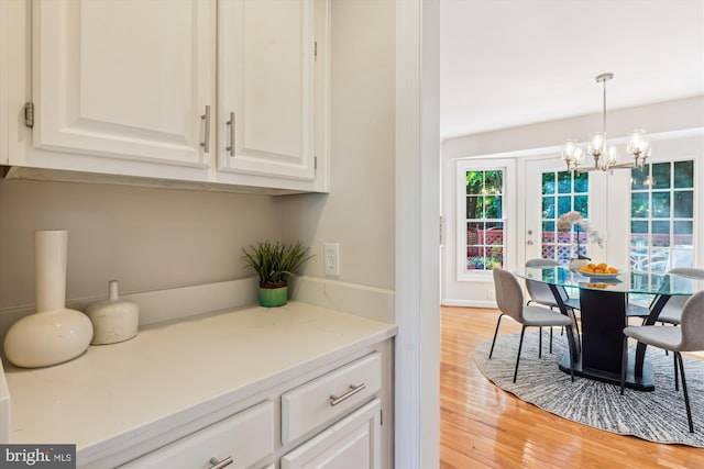 19802 Shady Brook Way, Gaithersburg, MD 20879 - dining area with a chandelier and light wood-style flooring