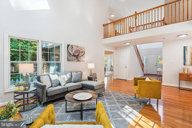19802 Shady Brook Way, Gaithersburg, MD 20879 - living area featuring a towering ceiling, wood finished floors, stairway, a skylight, and recessed lighting