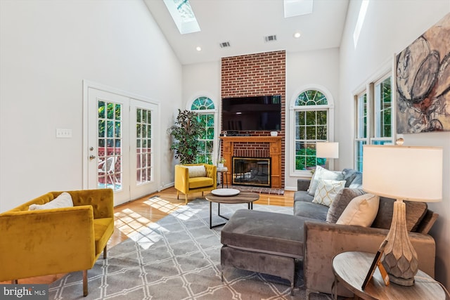 19802 Shady Brook Way, Gaithersburg, MD 20879 - living area featuring high vaulted ceiling, a skylight, a fireplace, wood finished floors, and french doors