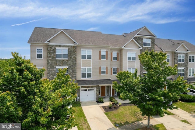 126 Backstretch Way, Prince Frederick, MD 20678 - multi unit property with stone siding, concrete driveway, and an attached garage