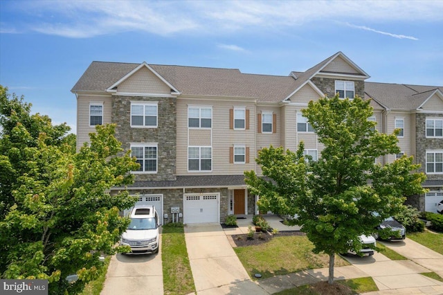 126 Backstretch Way, Prince Frederick, MD 20678 - townhome / multi-family property featuring stone siding, driveway, and an attached garage