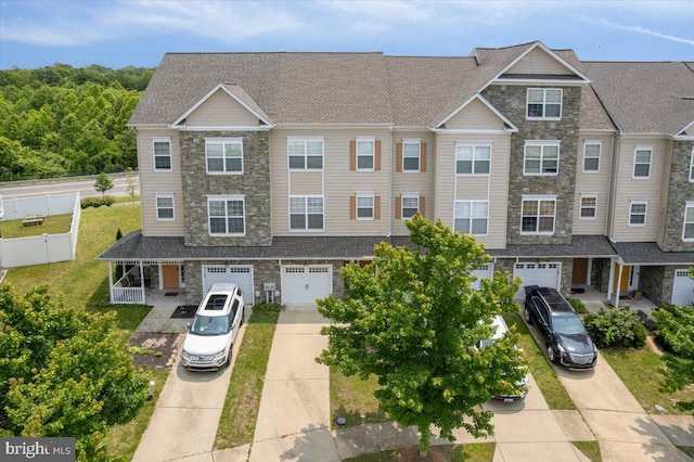 126 Backstretch Way, Prince Frederick, MD 20678 - townhome / multi-family property with stone siding, driveway, and an attached garage