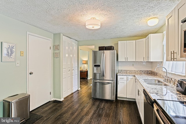 6786 Singletree Ct, Frederick, MD 21703 - kitchen featuring stainless steel appliances, a sink, dark wood-style flooring, light stone counters, and white cabinets