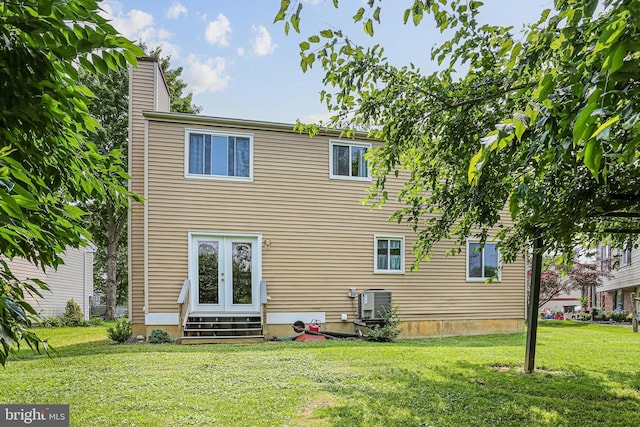 6786 Singletree Ct, Frederick, MD 21703 - back of house featuring entry steps, a yard, central AC unit, and a chimney