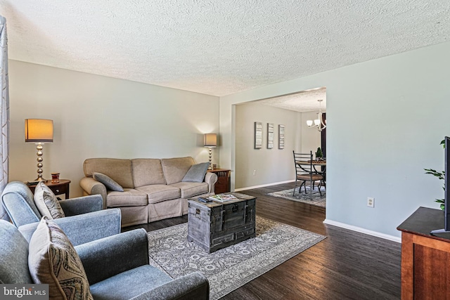 6786 Singletree Ct, Frederick, MD 21703 - living area with wood finished floors, a chandelier, baseboards, and a textured ceiling