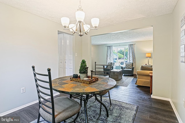 6786 Singletree Ct, Frederick, MD 21703 - dining space with a textured ceiling, a chandelier, dark wood-style flooring, and baseboards