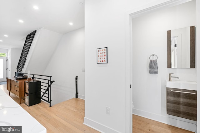 2206 E Fletcher St, Philadelphia, PA 19125 - hall with an upstairs landing, light wood-style flooring, recessed lighting, a sink, and baseboards