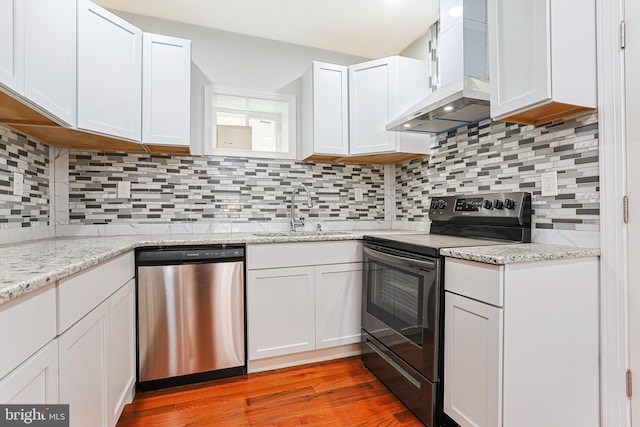 802 W Ritner St, Philadelphia, PA 19148 - kitchen with black range with electric cooktop, dishwasher, extractor fan, and white cabinetry