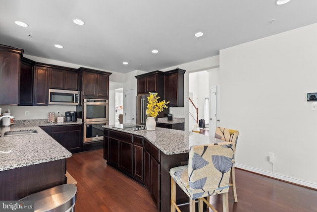 12916 Steam Mill Farm Dr, Brandywine, MD 20613 - kitchen featuring stainless steel appliances, a sink, a kitchen island, light stone countertops, and recessed lighting