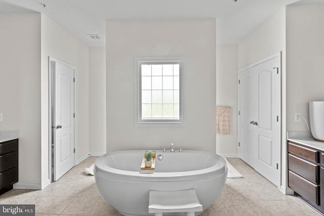 12916 Steam Mill Farm Dr, Brandywine, MD 20613 - bathroom featuring a freestanding tub, vanity, tile patterned floors, and a closet