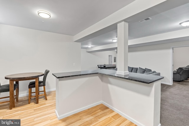 12916 Steam Mill Farm Dr, Brandywine, MD 20613 - kitchen featuring dark stone countertops, baseboards, open floor plan, and light wood-style floors