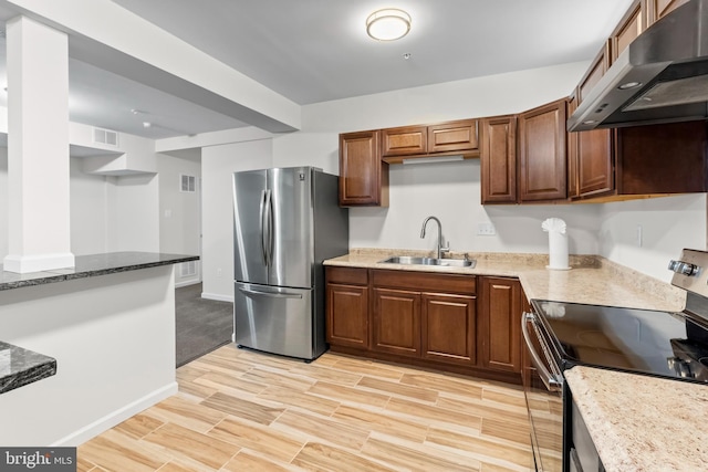 12916 Steam Mill Farm Dr, Brandywine, MD 20613 - kitchen featuring stainless steel appliances, a sink, under cabinet range hood, light wood finished floors, and light stone countertops