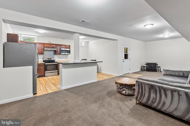 12916 Steam Mill Farm Dr, Brandywine, MD 20613 - living room featuring light colored carpet, light wood-style flooring, and baseboards