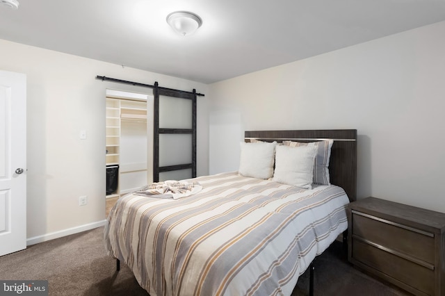 12916 Steam Mill Farm Dr, Brandywine, MD 20613 - bedroom with a barn door, carpet flooring, a walk in closet, and baseboards