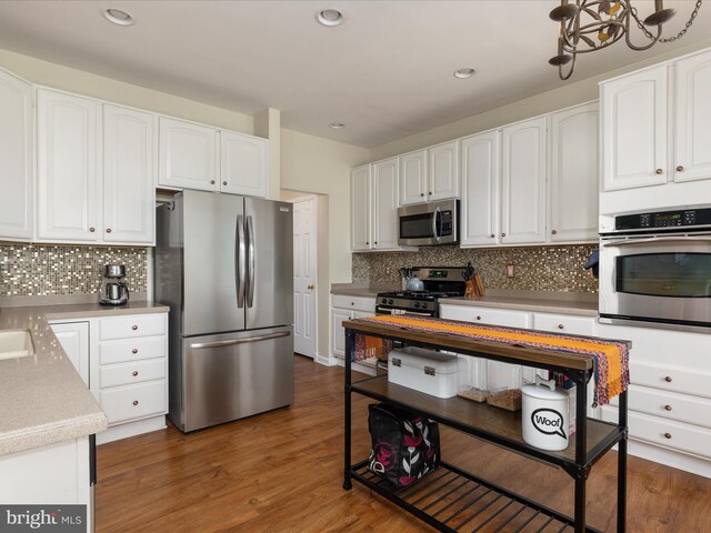 6040 Gayleburg Pl, Gainesville, VA 20155 - kitchen with stainless steel appliances, tasteful backsplash, white cabinets, recessed lighting, and wood finished floors