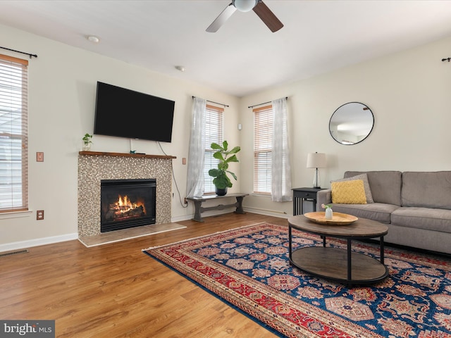 6040 Gayleburg Pl, Gainesville, VA 20155 - living room featuring ceiling fan, wood finished floors, a tile fireplace, and baseboards