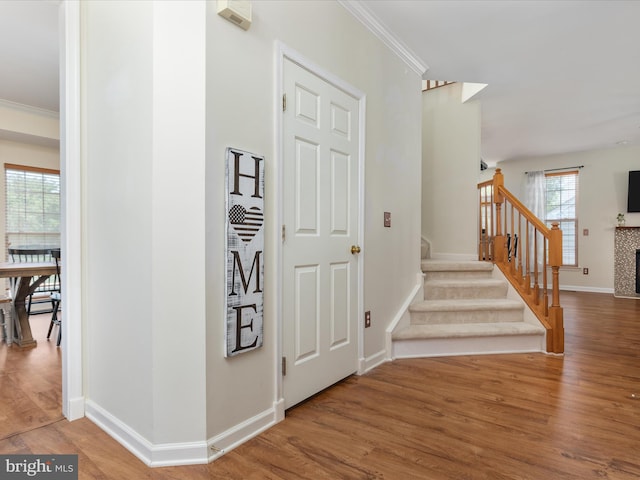6040 Gayleburg Pl, Gainesville, VA 20155 - foyer entrance with wood finished floors, crown molding, baseboards, stairs, and a fireplace
